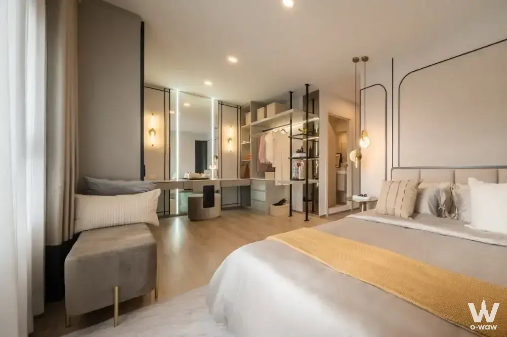 Luxury master bedroom with king bed, floating vanity, and open closet in neutral tones