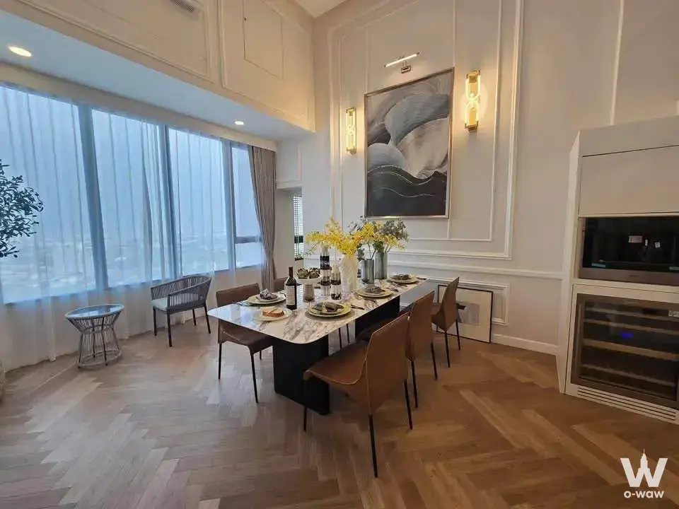 Dining area in 2-bed Landmark@MRTA condo with marble table, herringbone floors, and floor-to-ceiling windows