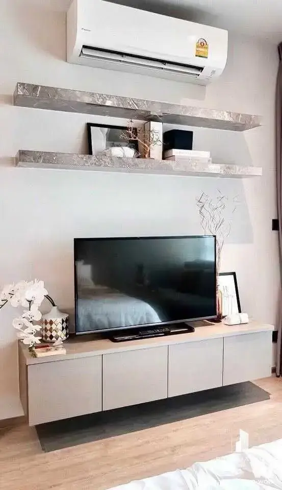Open-plan living space in Life One Wireless with marble shelves and a low floating media console