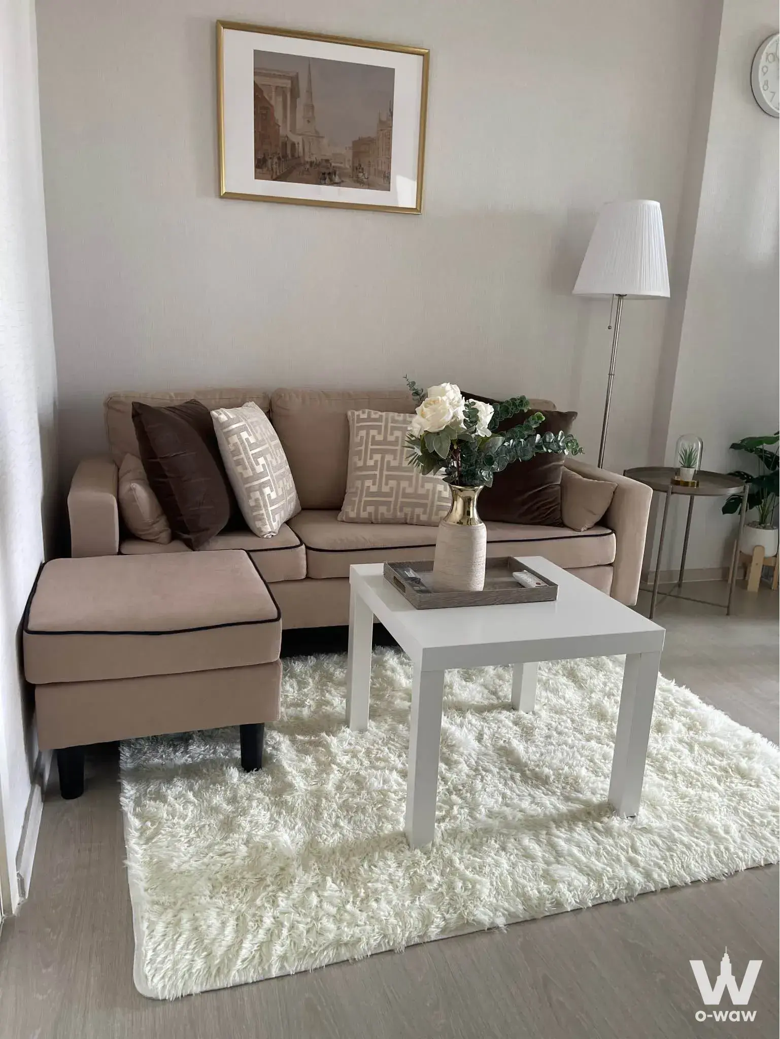 Bright living room in Aspire Rattanatibet 1 with beige sofa and white coffee table