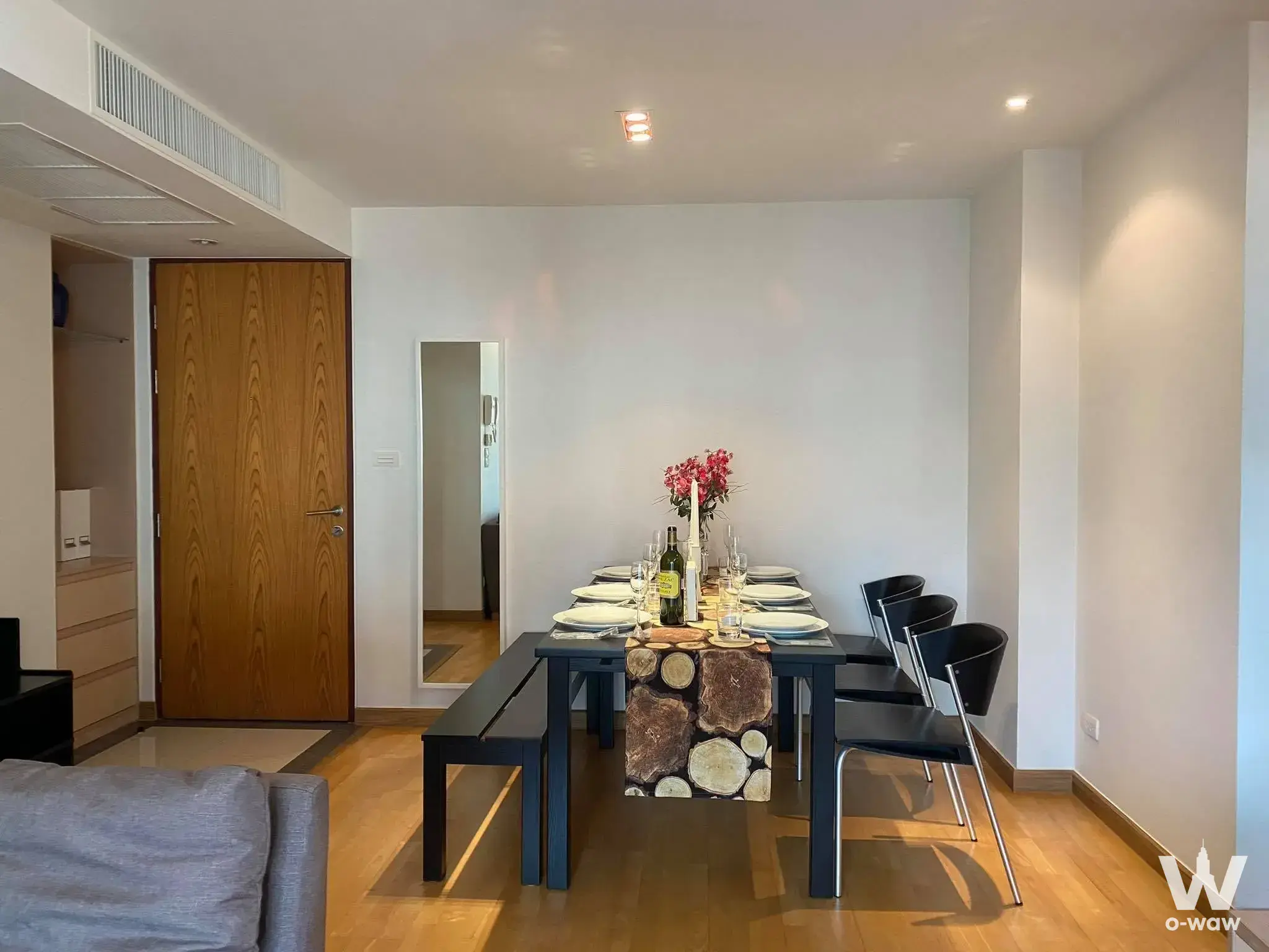 Modern dining area in 3-bed condo for rent at Residence 52 featuring blue table, oak floors and bright white walls