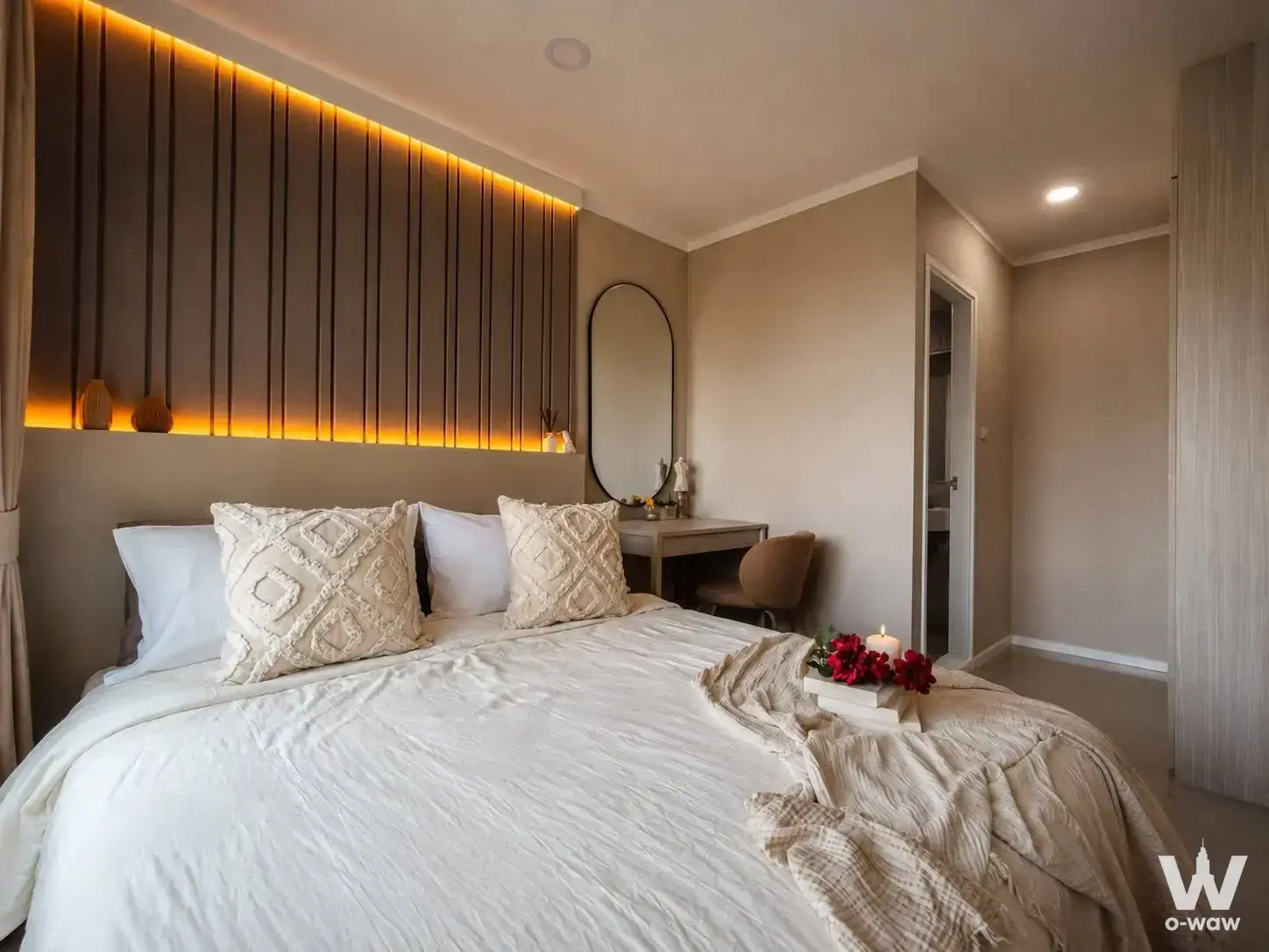 Master bedroom in Lumpini Ville Naklua condo with dark wood slat headboard and warm amber LED lighting