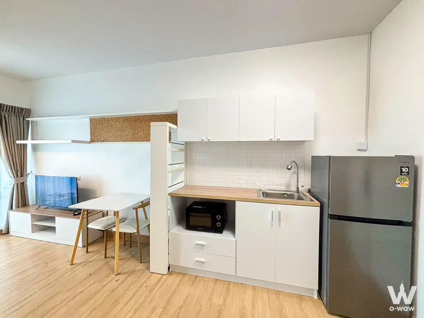 Modern 1-bed condo for rent in Condo A Space Kaset - Nawamin with open-plan living, dining, and kitchenette area