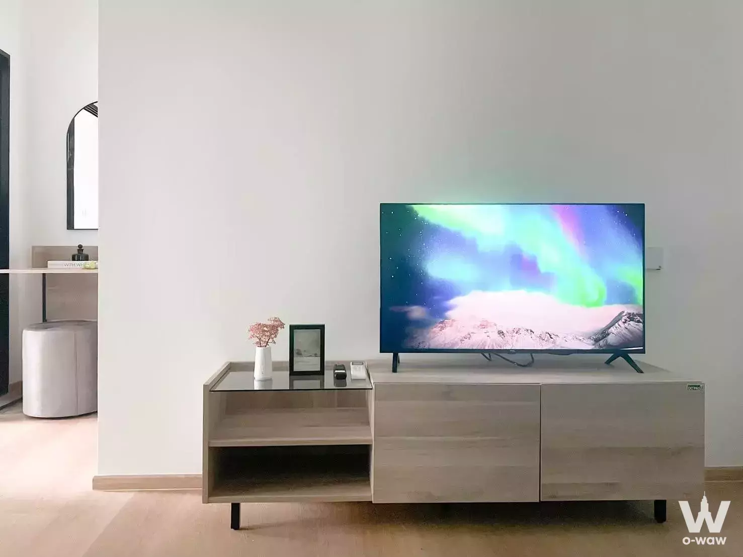 Bright living room in Chewathai Hallmark Charan 13 condo with wood floors, media console, and TV