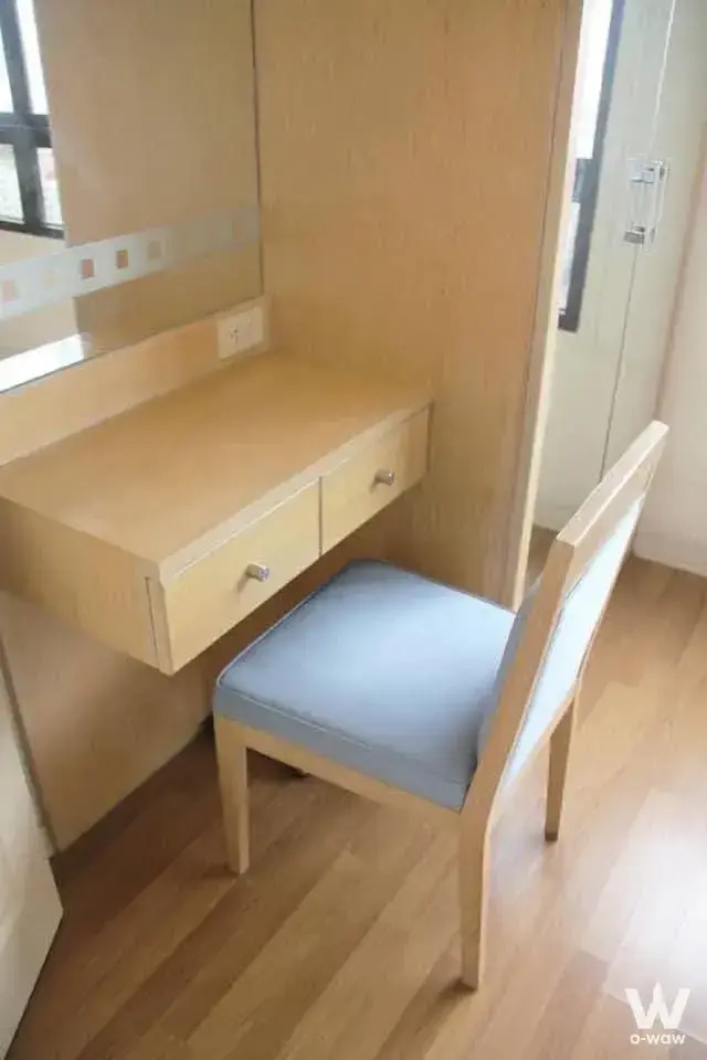 Bedroom study nook in Lumpini Place Boromarajonani condo with wall-mounted desk mirror and light blue chair