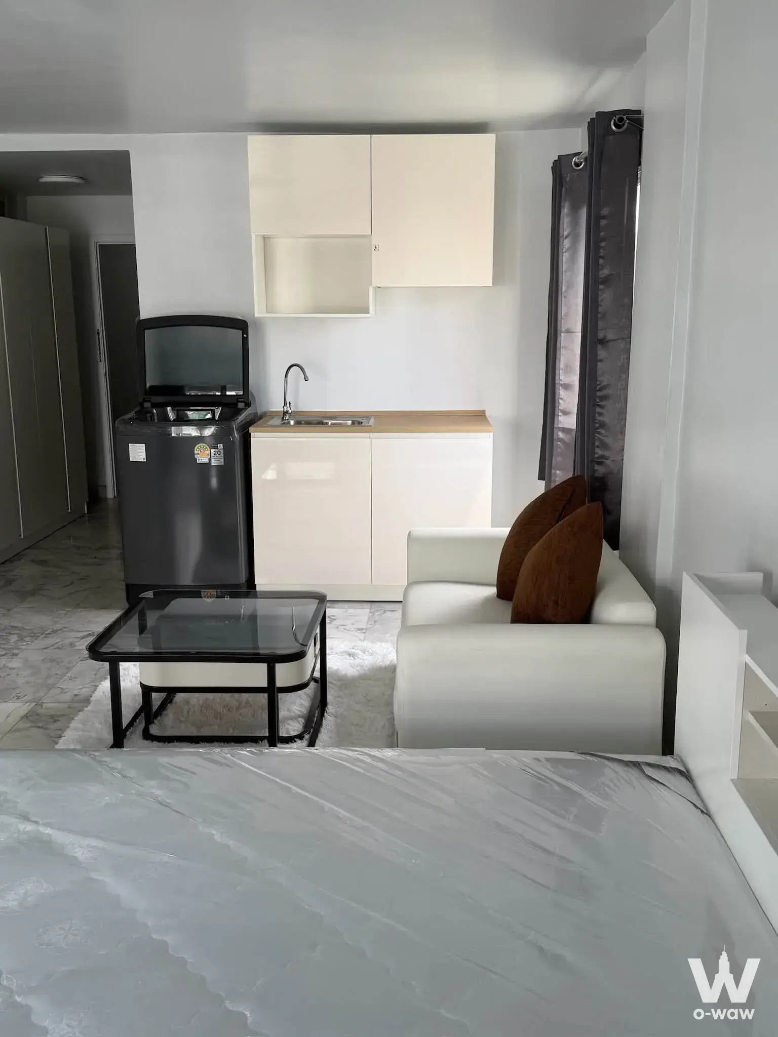 Modern 1-bed condo for rent in Cityvilla with open-plan living, kitchenette, and grey marble flooring