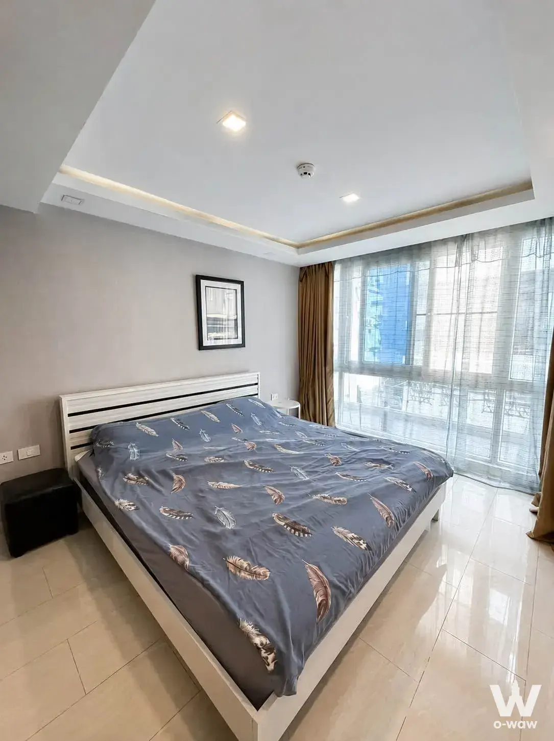 Grand Avenue Residence bedroom with queen bed, grey walls, and floor-to-ceiling window