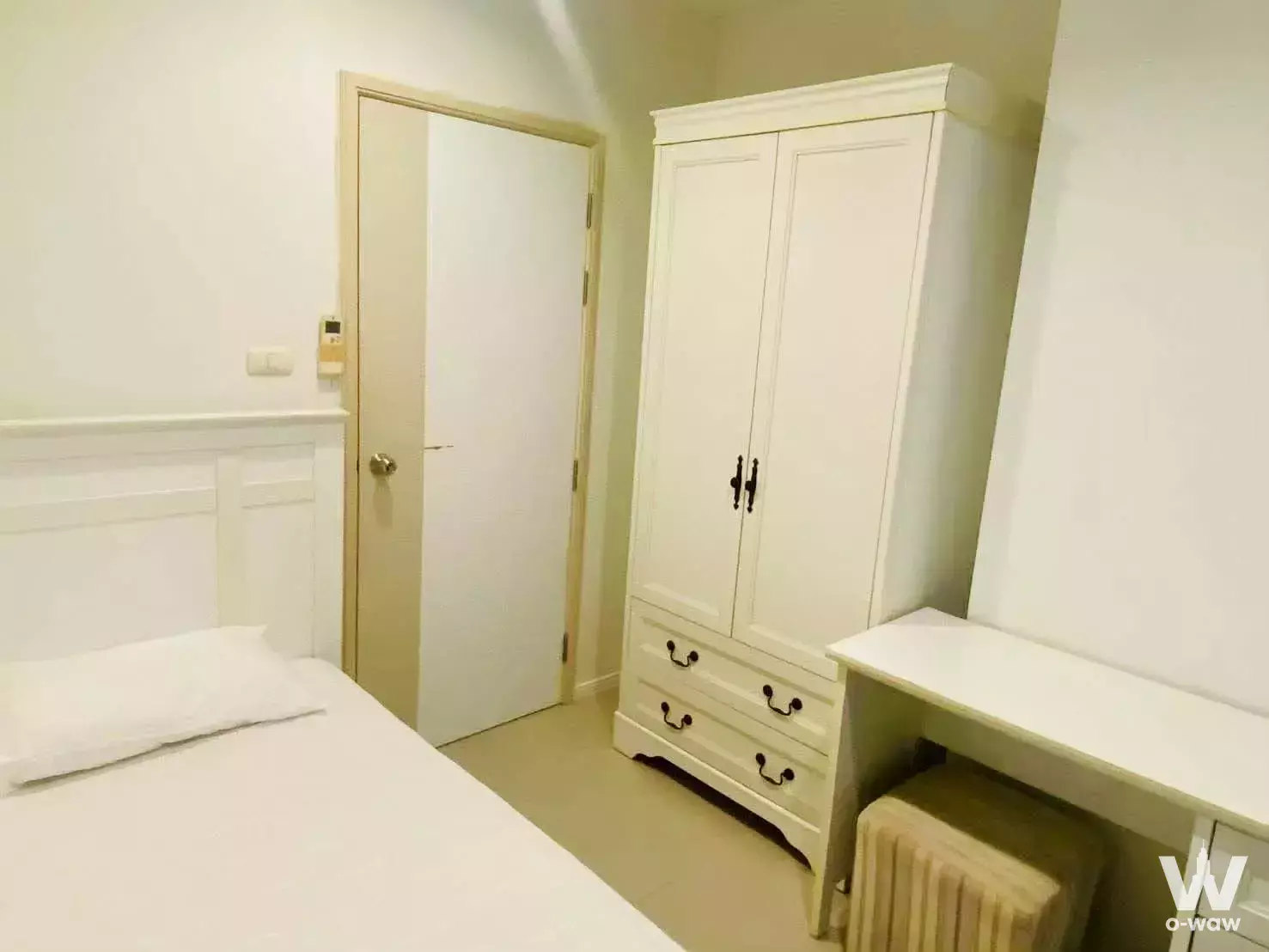 Furnished bedroom with white wardrobe and desk in 2-bed Lumpini Park Beach Jomtien A condo for rent