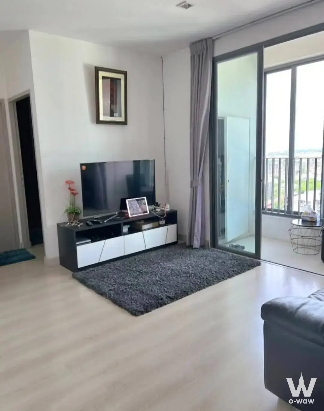 Modern living room in 2-bed Ideo Mobi Sukhumvit 81 condo with TV console and balcony view