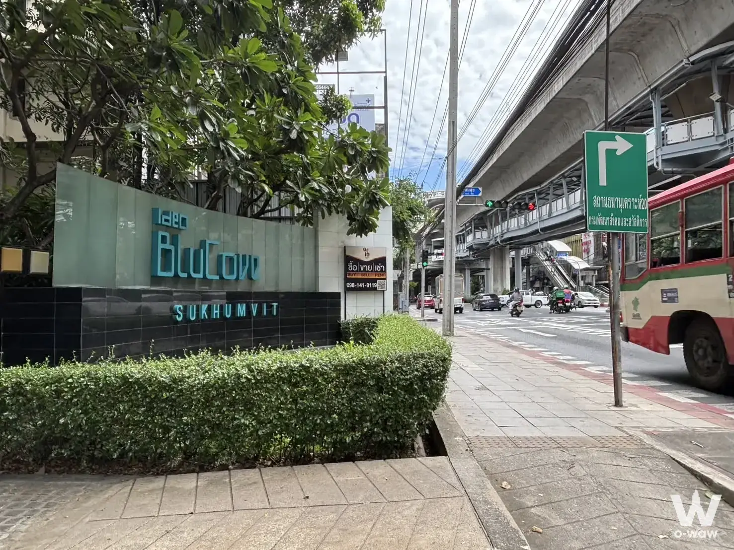 Ideo BluCove Sukhumvit condo entrance with teal signage and busy city street view