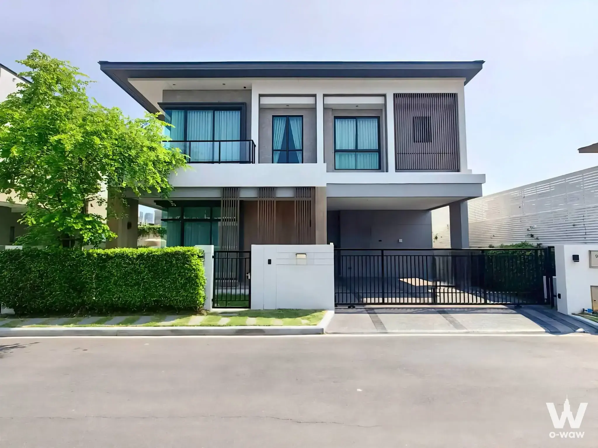 Modern 2-story house exterior with wood slats and carport for rent at Bangkok Boulevard Bangna KM.5