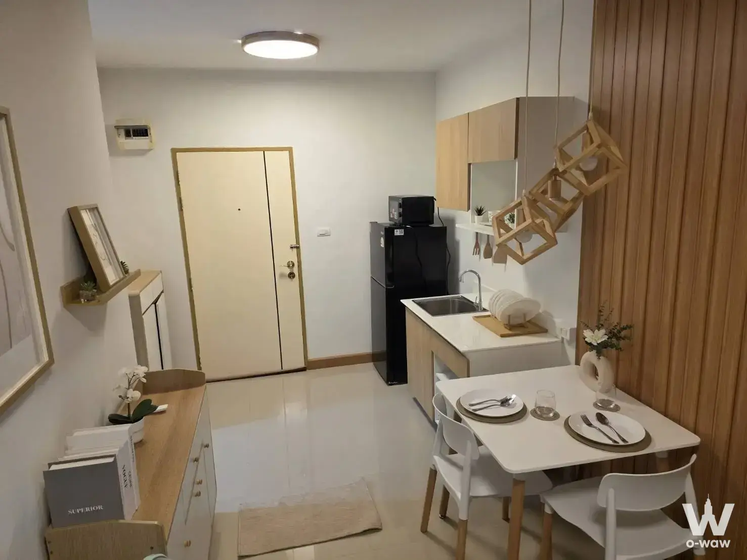 Modern 1-bed condo for rent in A space Sukhumvit 77 featuring open-plan kitchen and dining area with light wood cabinetry