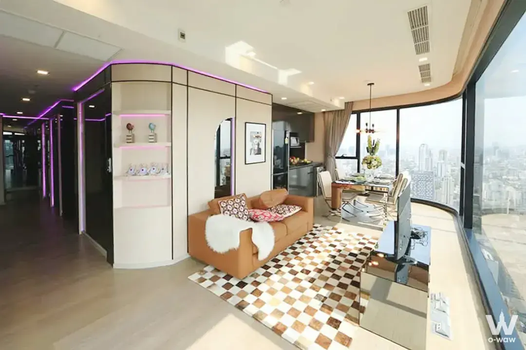 Ashton Asoke 3-bed condo for rent featuring open-plan living, city skyline views, and modern eclectic decor