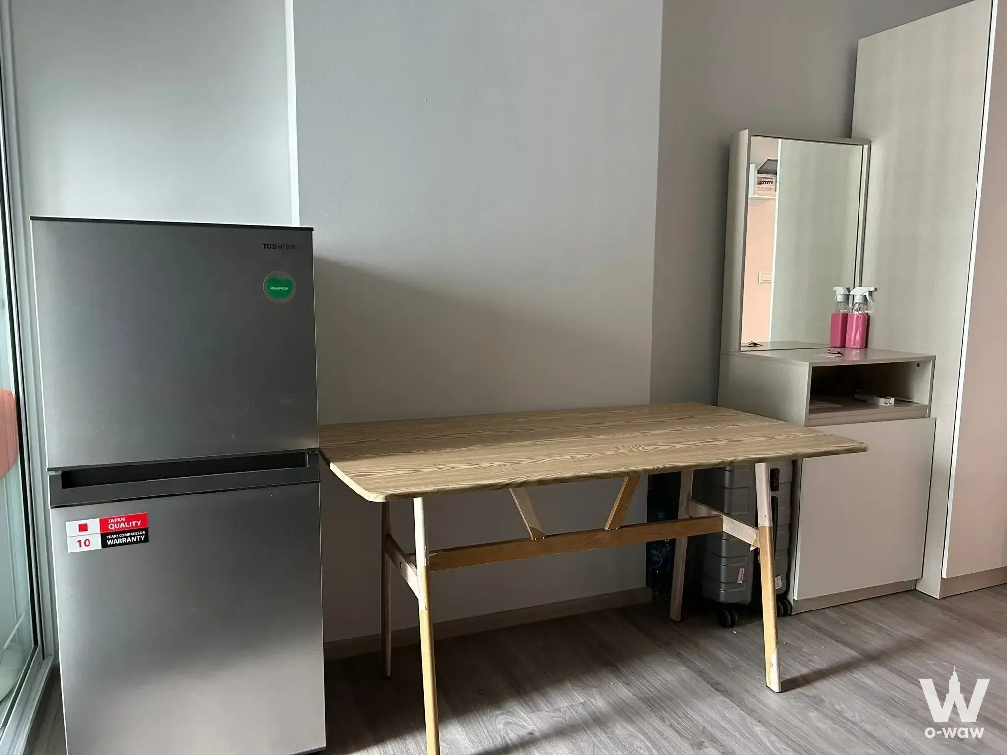 Minimalist 1-bed condo bedroom in Regent Home Bangna with oak dining table and wardrobe