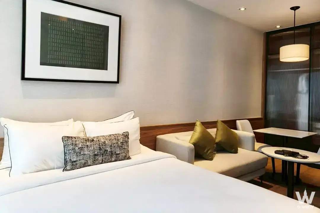 Queen bedroom in a Park Origin Phrom Phong condo featuring wood paneling and contemporary desk setup