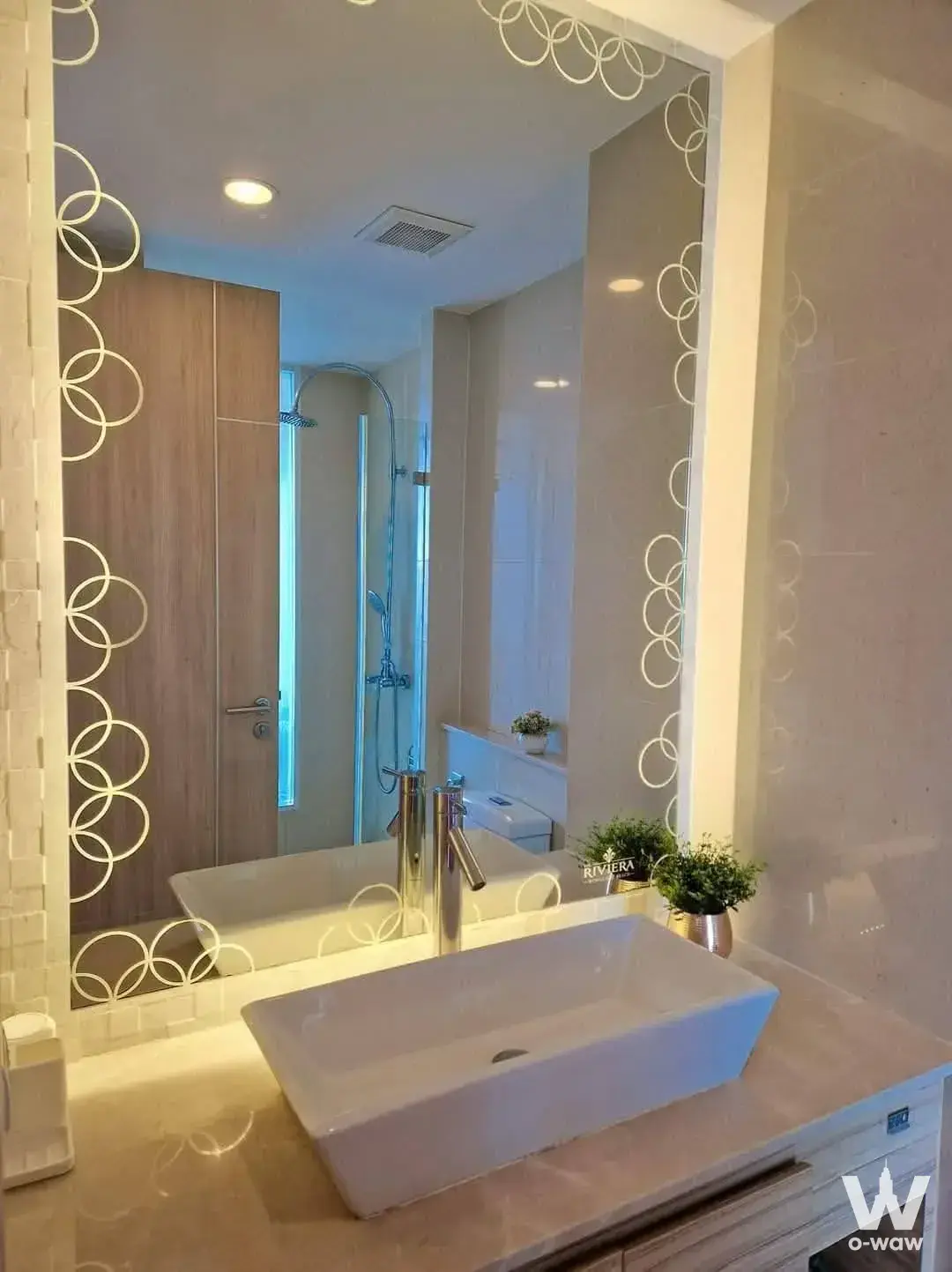Modern bathroom with vessel sink and illuminated circular mirror in Riviera Wongamat Beach condo for sale