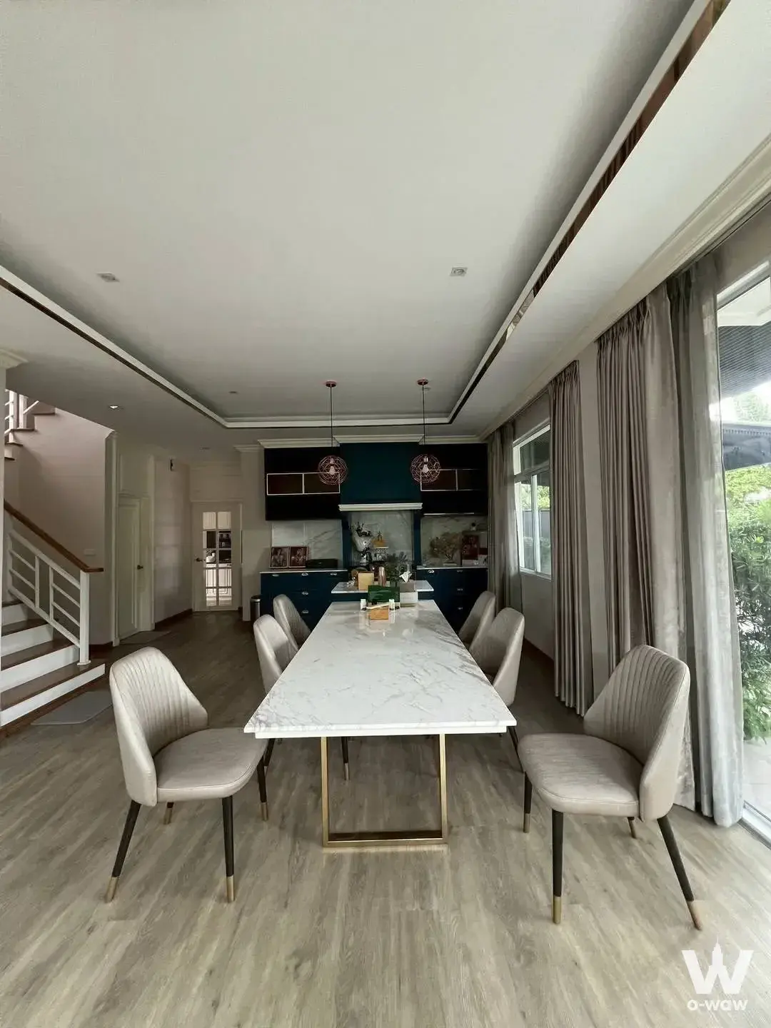 Modern dining area with marble table and gold accents in 3-bed house for sale at Casa Premium On Nut Wongwaen
