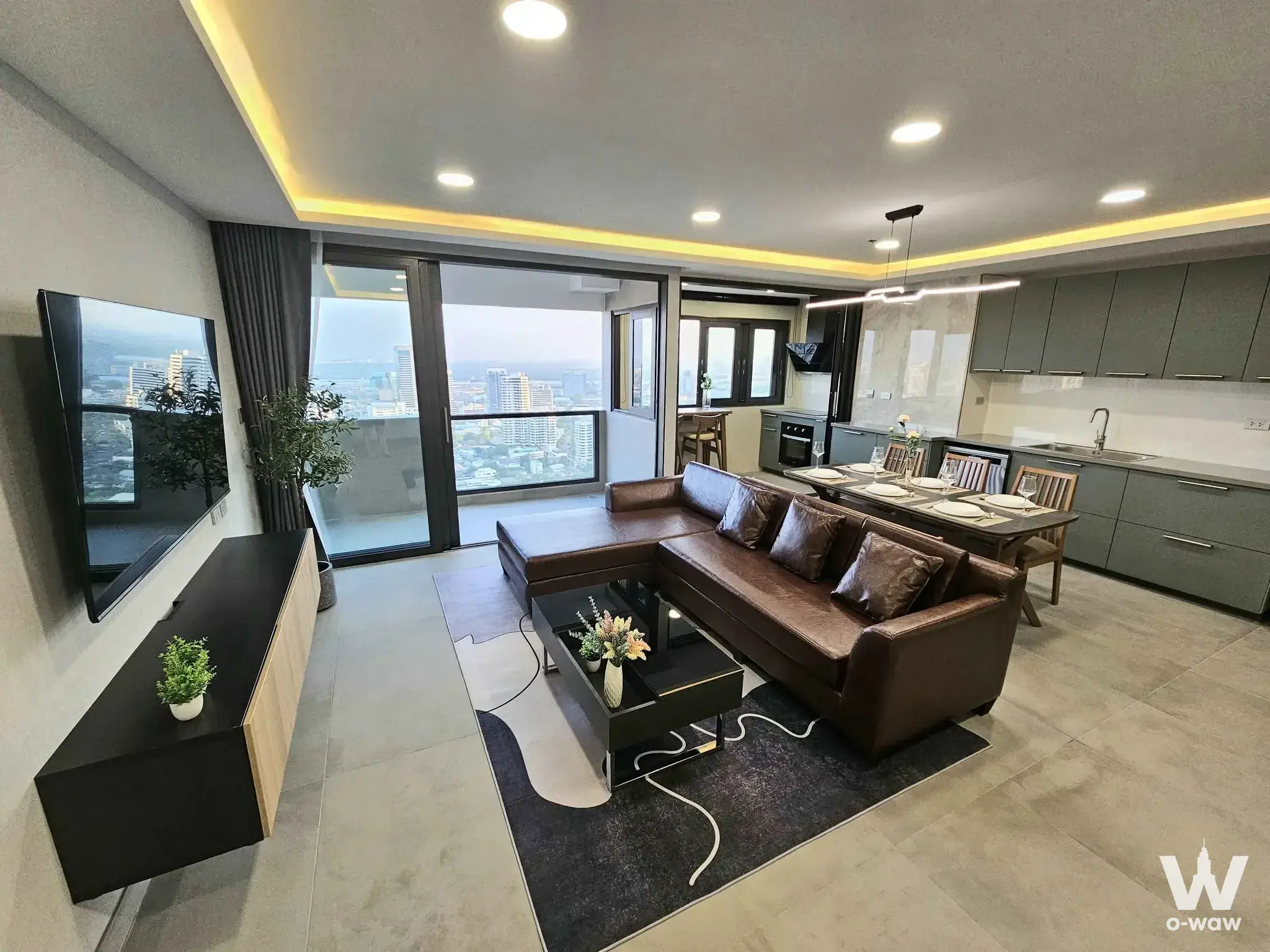 Modern open-plan living and dining area in Diamond Sukhumvit condo with city views and grey tiles