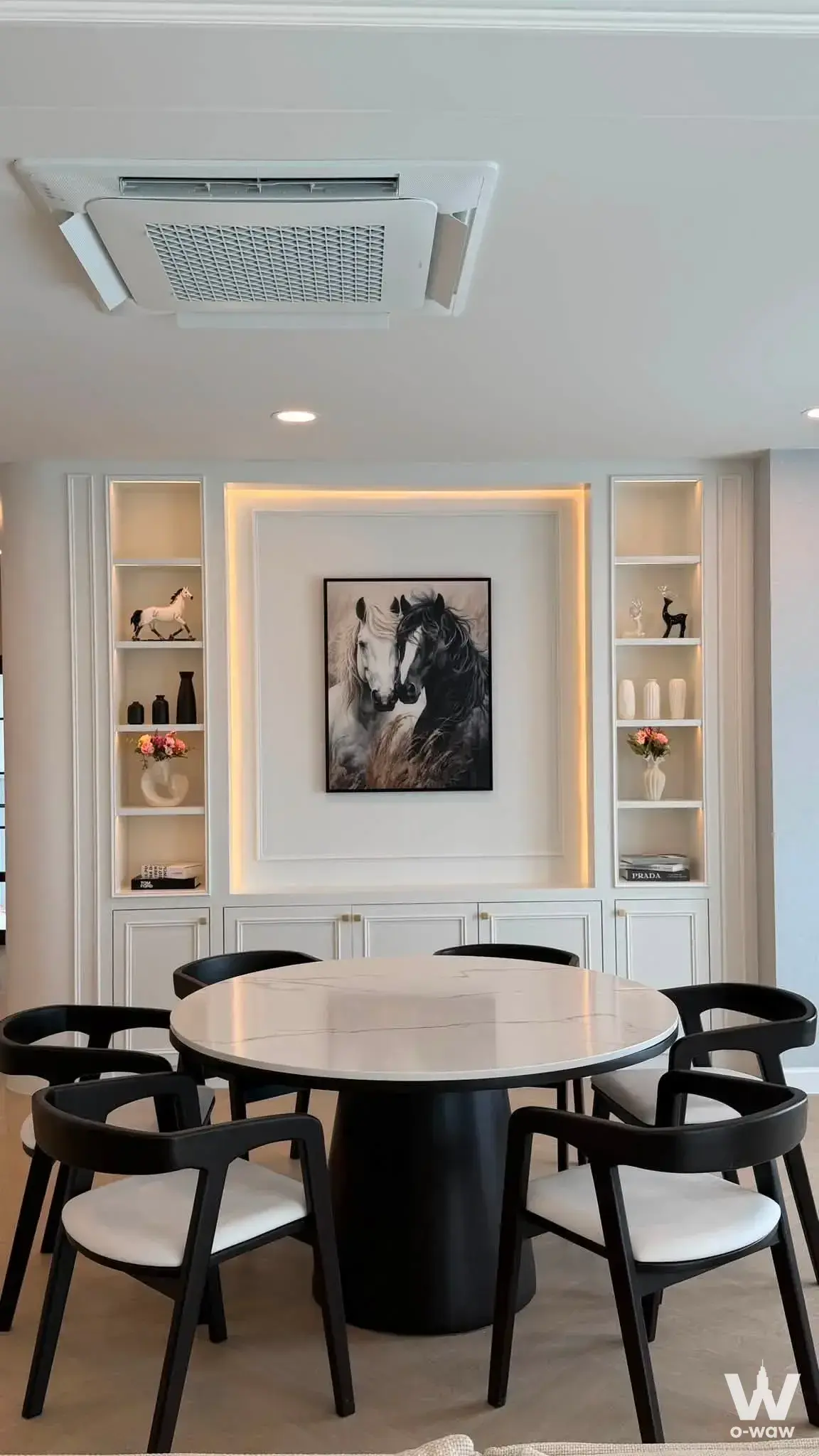 Dining room in a 4-bed Centro Bangna house featuring a marble table and LED-lit built-in cabinetry