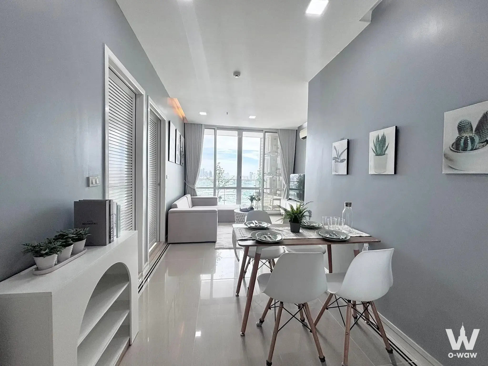 Modern living dining area in 2-bed condo for sale at TC Green Rama 9 with city views