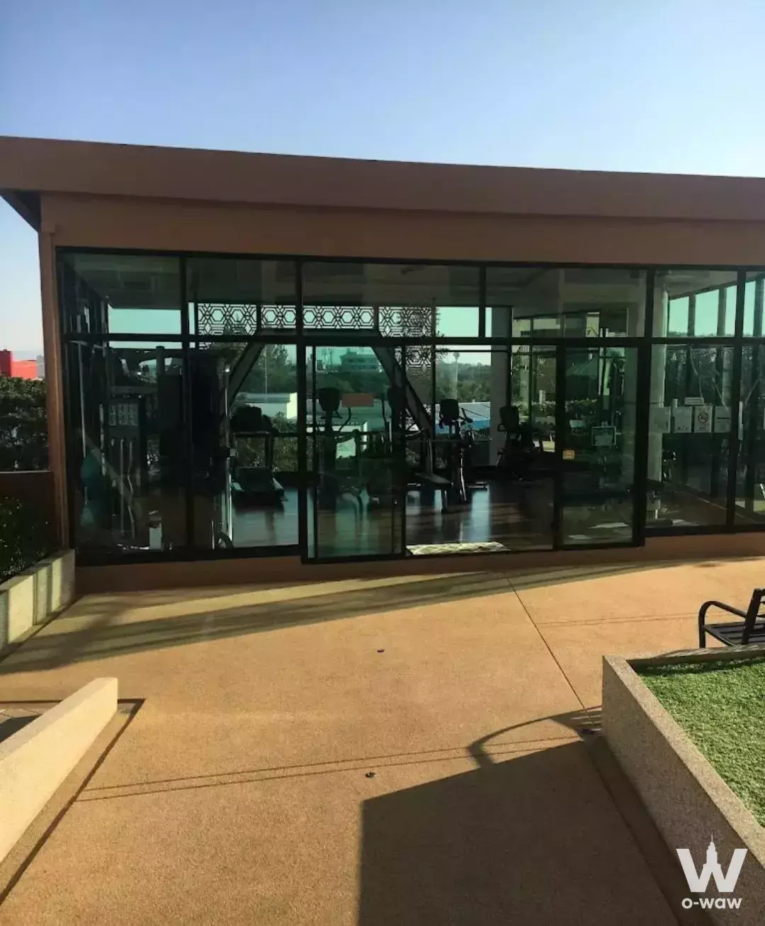 Modern rooftop gym with glass facade and exercise equipment at Supalai Monte II Chiangmai 1-bed condo