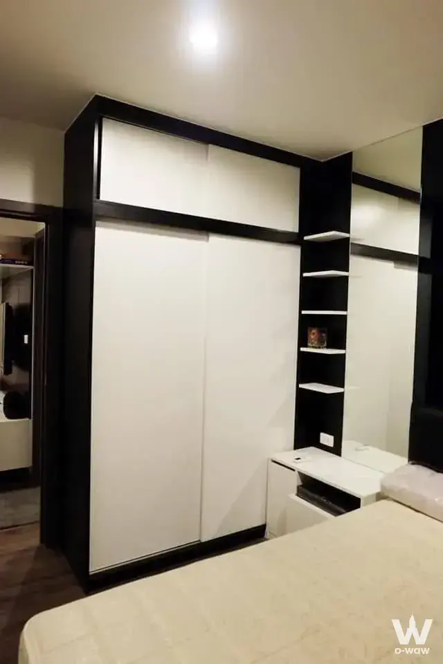 Floor-to-ceiling wardrobe with black trim in a bedroom of a 1-bed condo at THE BASE Park West