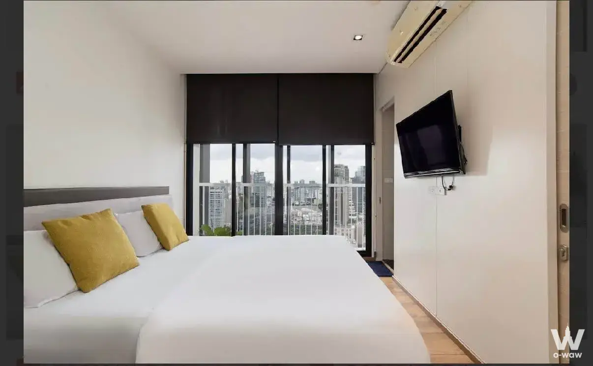 Bedroom with TV and balcony view for sale in Park Origin Phrom Phong condo