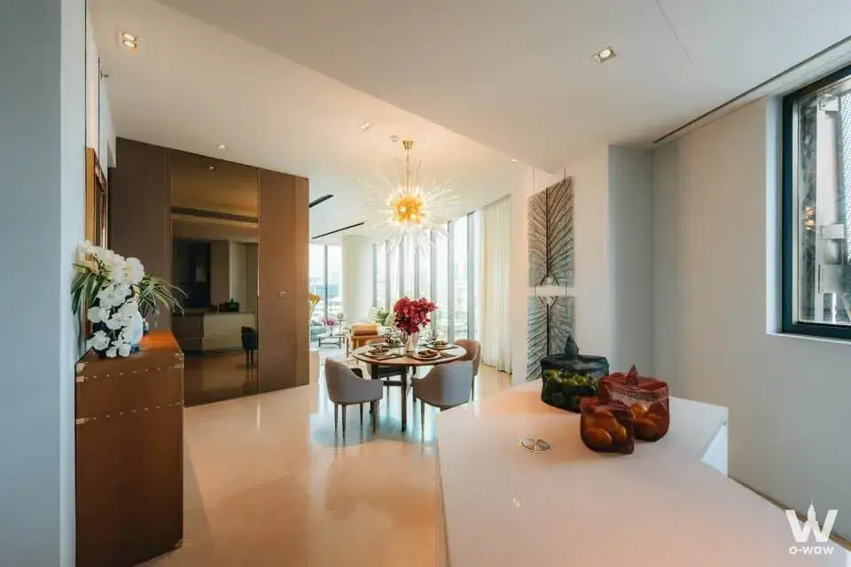 Dining room in a 2-bed Banyan Tree Riverside rental condo with a gold chandelier and city skyline view