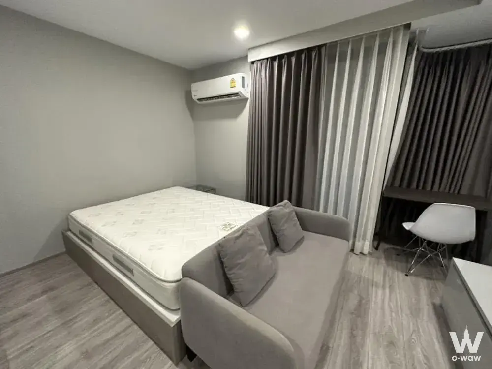 Modern 1-bed condo for sale in Maestro 12 Ratchathewi featuring light grey flooring, beige platform bed, and