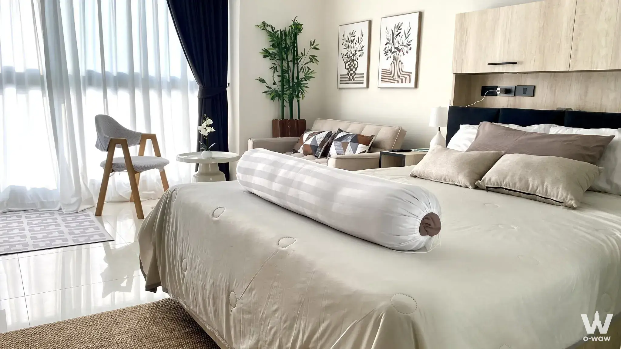 Bright bedroom in Novana Residence condo rental with large bed, navy drapes, and natural light