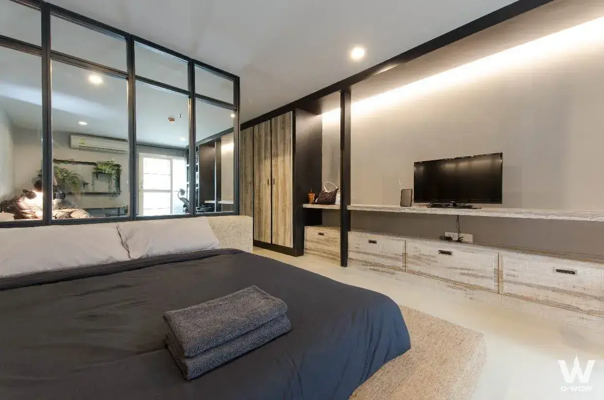 Bedroom in Regent Home 6/1 Prachachuen with king bed, glass partition, and floating TV console