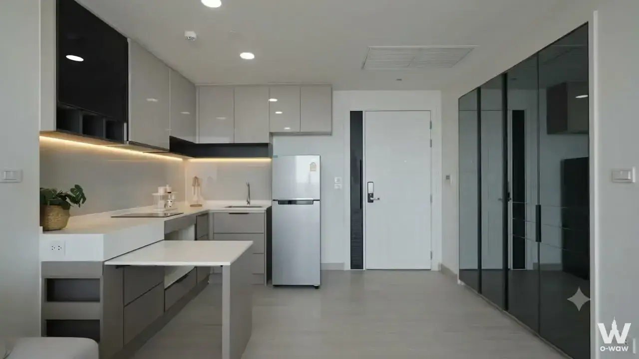 Modern L-shaped kitchen in a 333 Riverside condo featuring matte grey cabinets and a white quartz island