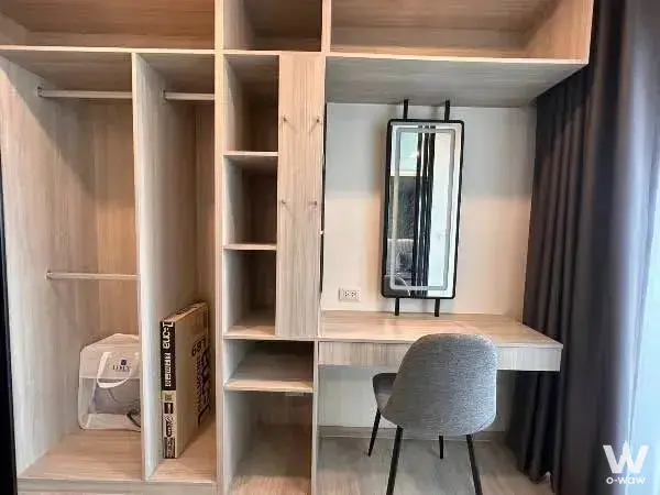 Built-in oak wardrobe and desk area in an unfurnished bedroom at Origin Plug & Play Srinakarin