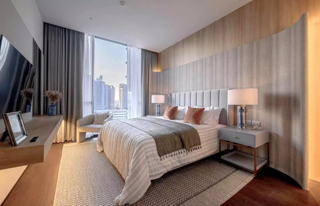 Modern bedroom with tufted headboard and city views in 2-bed LAVIQ Sukhumvit 57 condo for rent