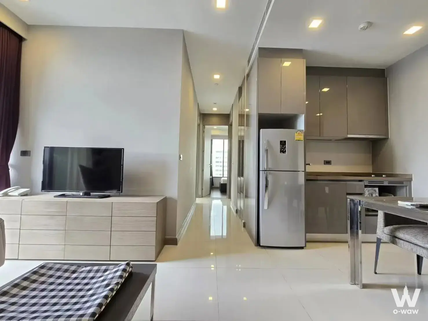 Open-plan living and kitchen in a 2-bed M Silom condo sale with glossy floors