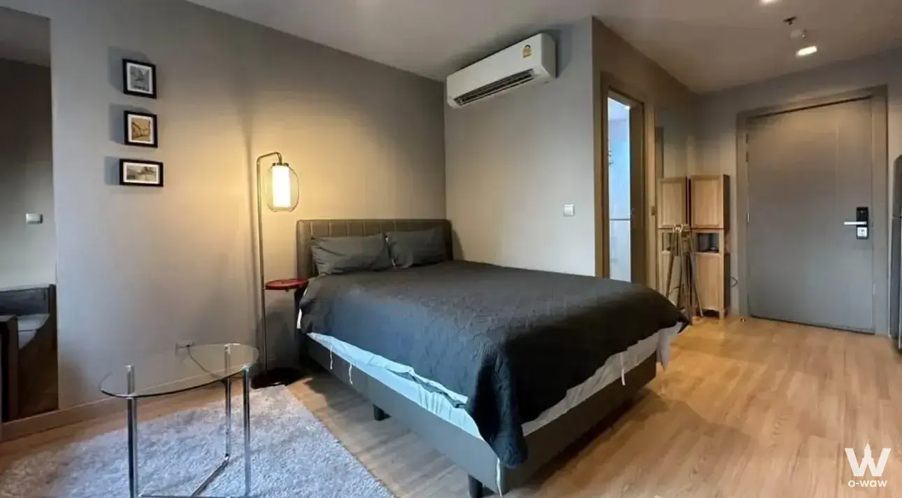 Modern 1-bed bedroom in Life Asoke Rama 9 condo with queen bed, wood floors and neutral decor