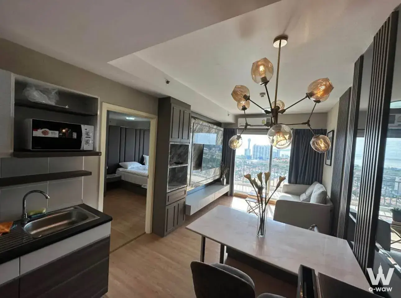 Open-plan studio with marble dining table and city view in Supalai Mare Pattaya for sale