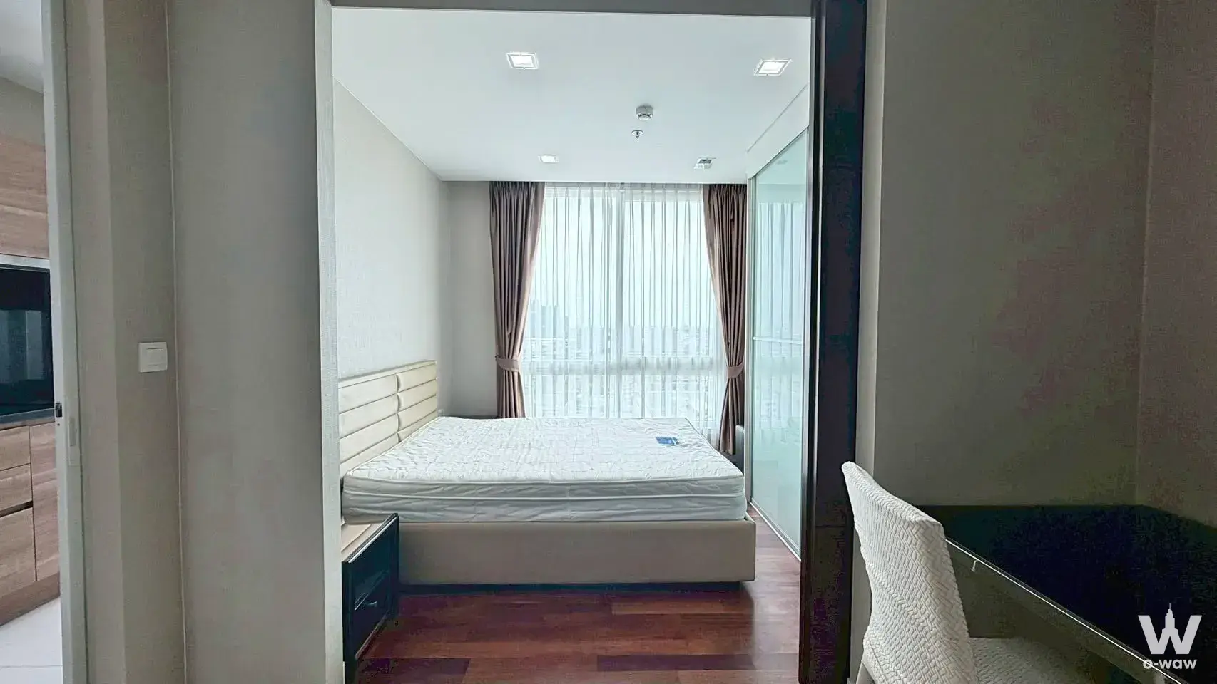 Bright bedroom in Polis Condo 1-bed rental with queen bed, wood floors, and balcony views
