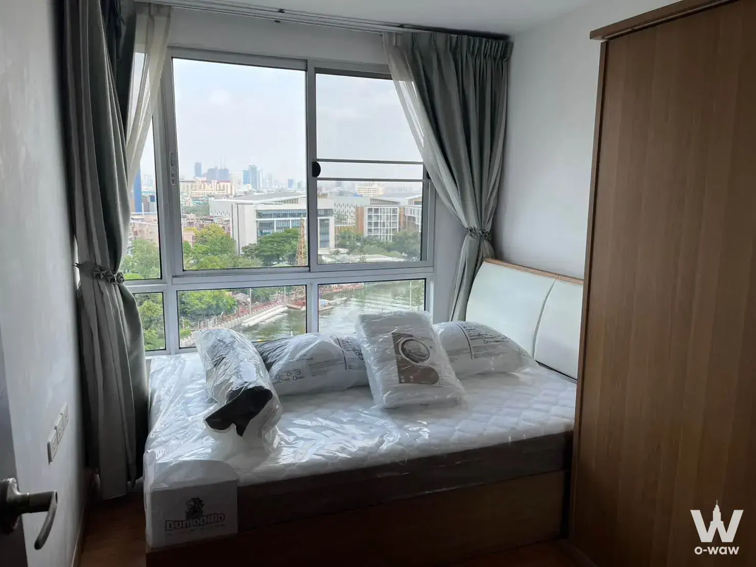 Bright bedroom in a 1-bed condo for rent at THE BASE Sukhumvit 77 with floor-to-ceiling windows and city views
