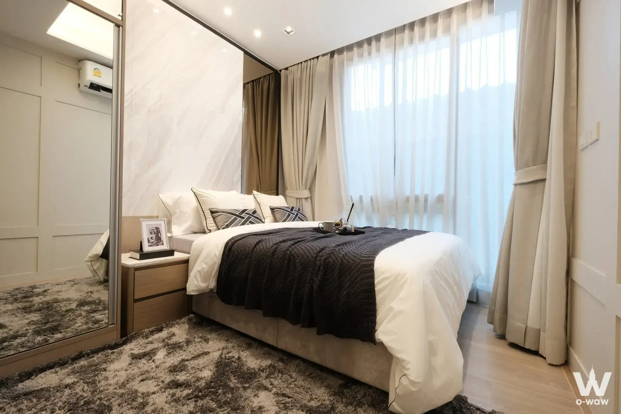 Master bedroom for sale in The Moment Ratchada 19 featuring marble headboard and mirrored wardrobe