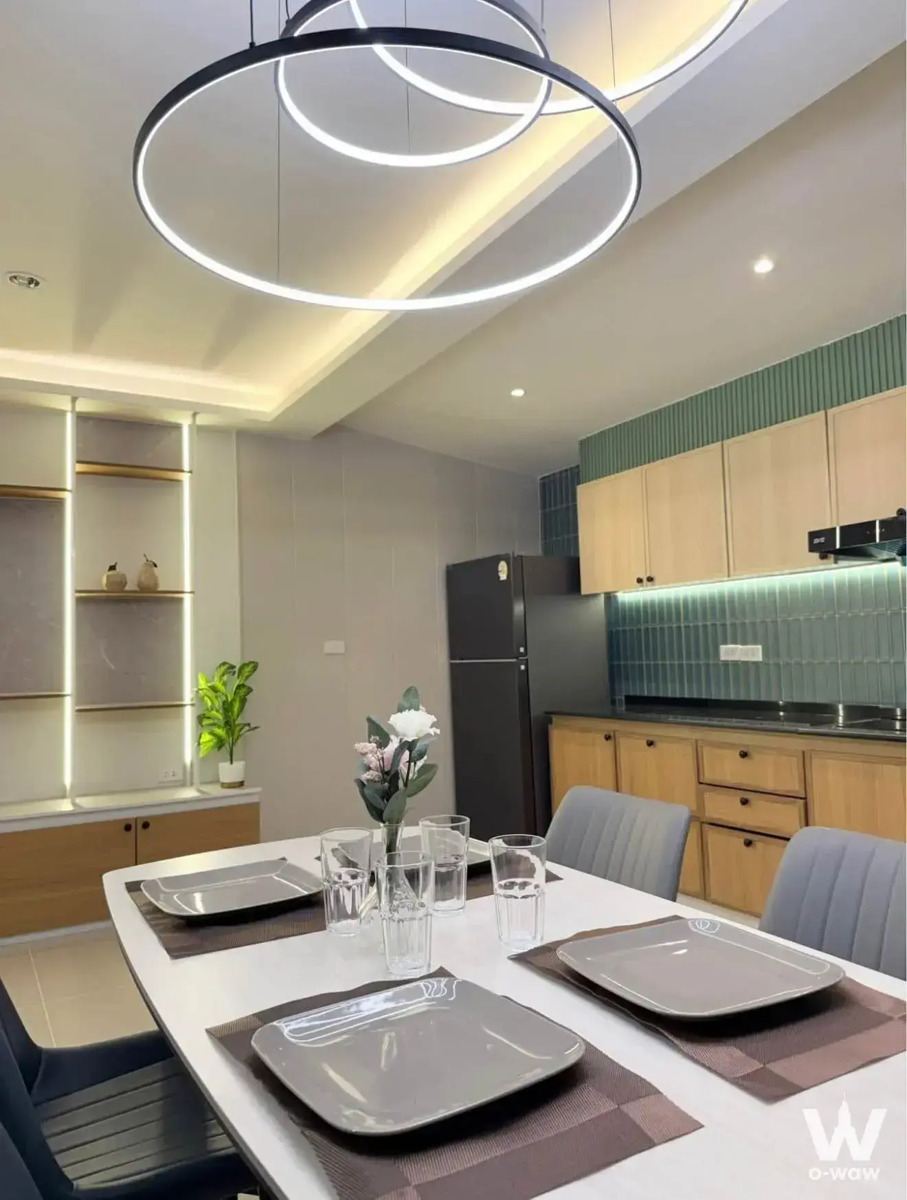 Modern dining and kitchen in 3-bed house for rent at Pleno Sukhumvit-Bangna 2 with sage green backsplash