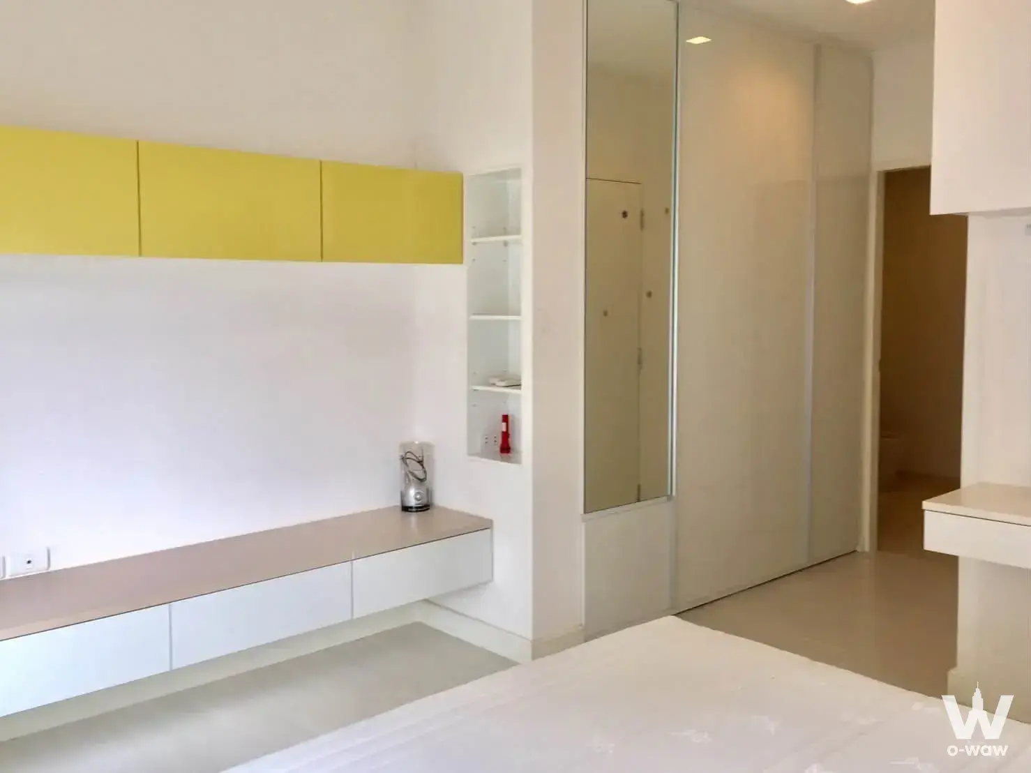 Bright bedroom in The Room Ratchada-Ladprao condo with white platform bed and built-in wardrobe