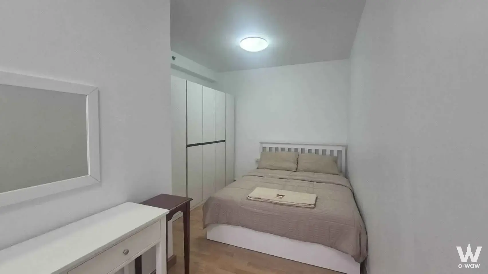 Compact bedroom in City Home Rattanathibet condo with built-in wardrobe and white vanity desk