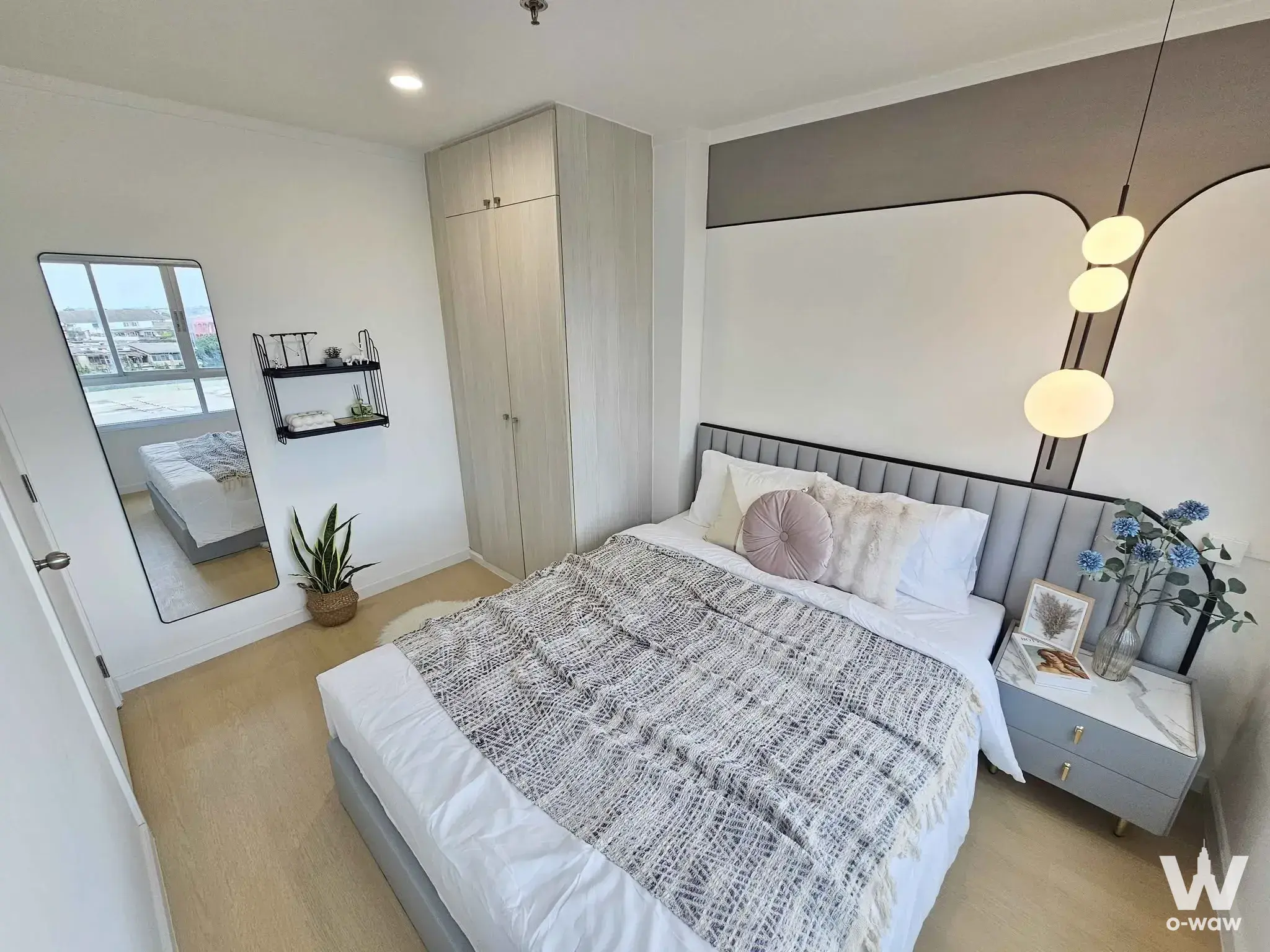 1-bed condo for sale in Lumpini Ville Sukhumvit 77-2 bedroom with grey upholstered bed and built-in wardrobe