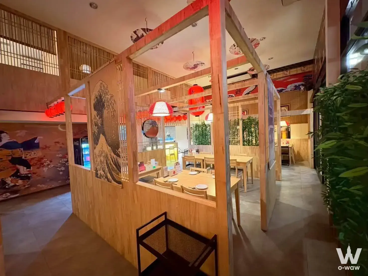 This Japanese dining room in a 0-bed condo for sale in TC Green Building A features Hokusai art and red lanterns