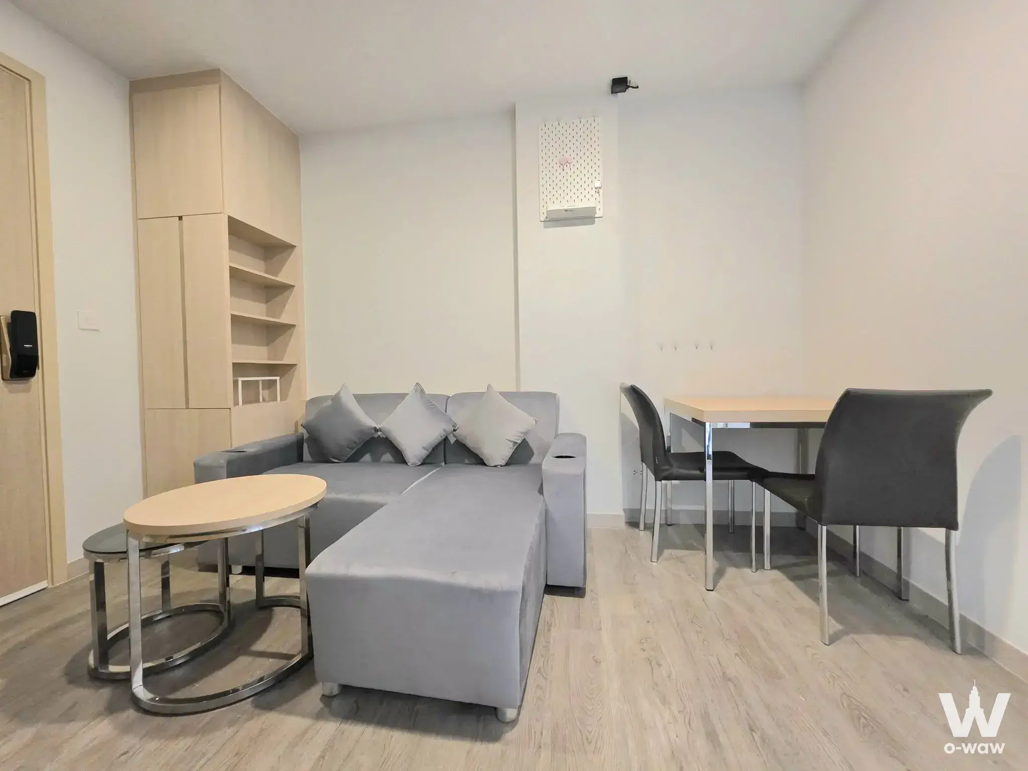 The Shade Sathorn 1 living room with grey sectional and chrome accents