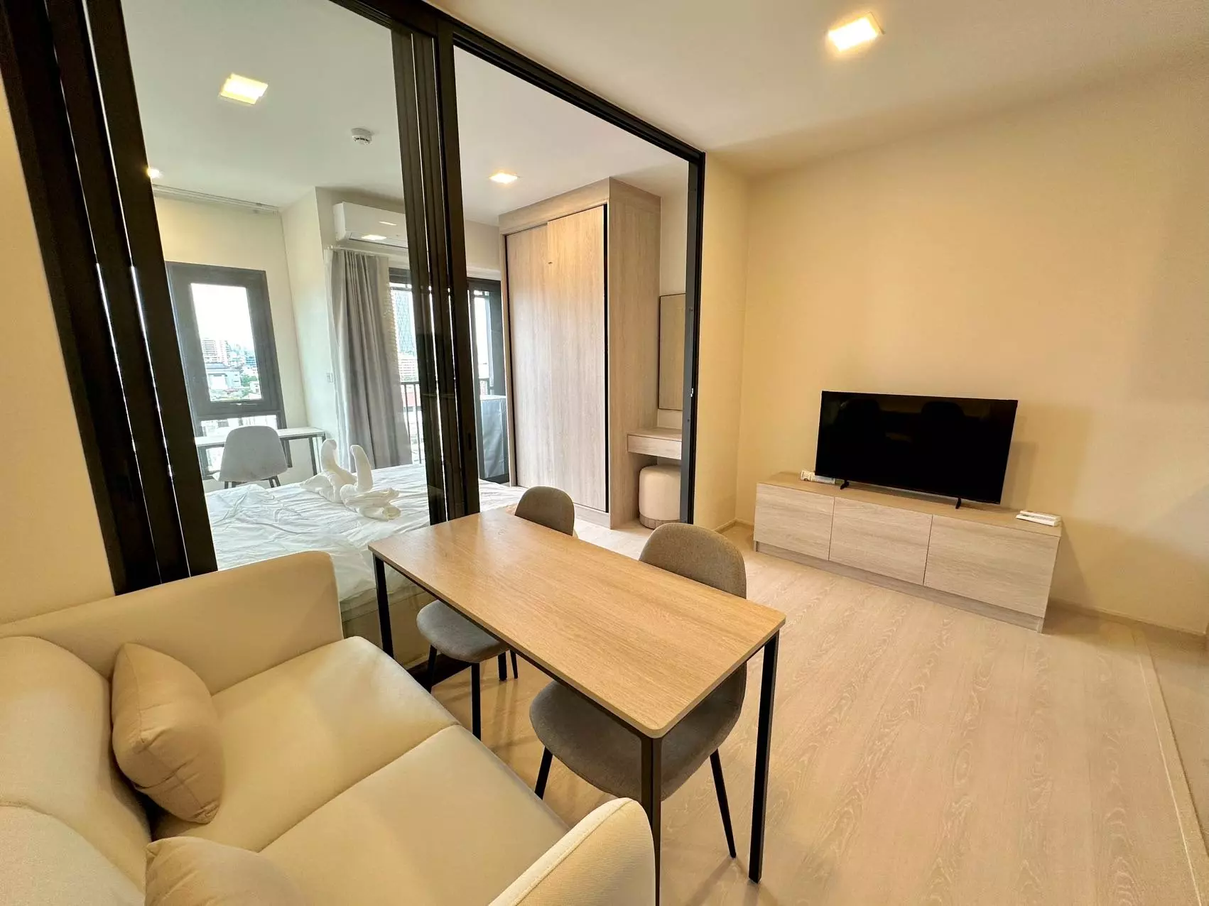 Bright 1-bed studio in FLO by Sansiri with glass partition, wood floors, and city view balcony