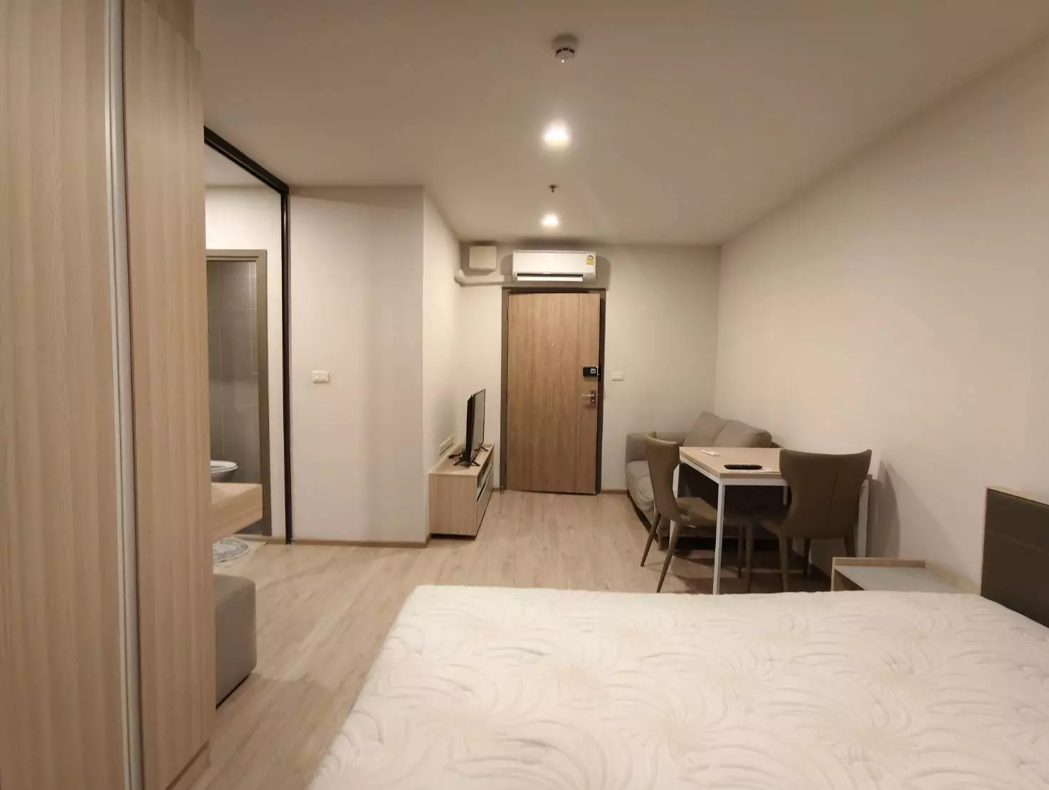 Bright 1-bed condo for rent in Ideo O2 with light wood floors, modern furniture, and an open bathroom view