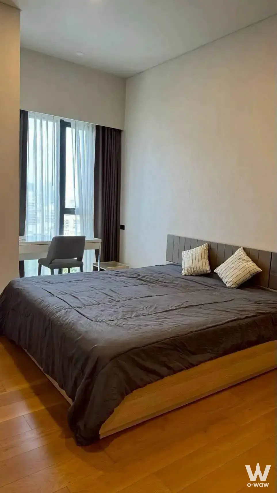 Siamese Exclusive 31 bedroom with queen bed, grey headboard, and city view