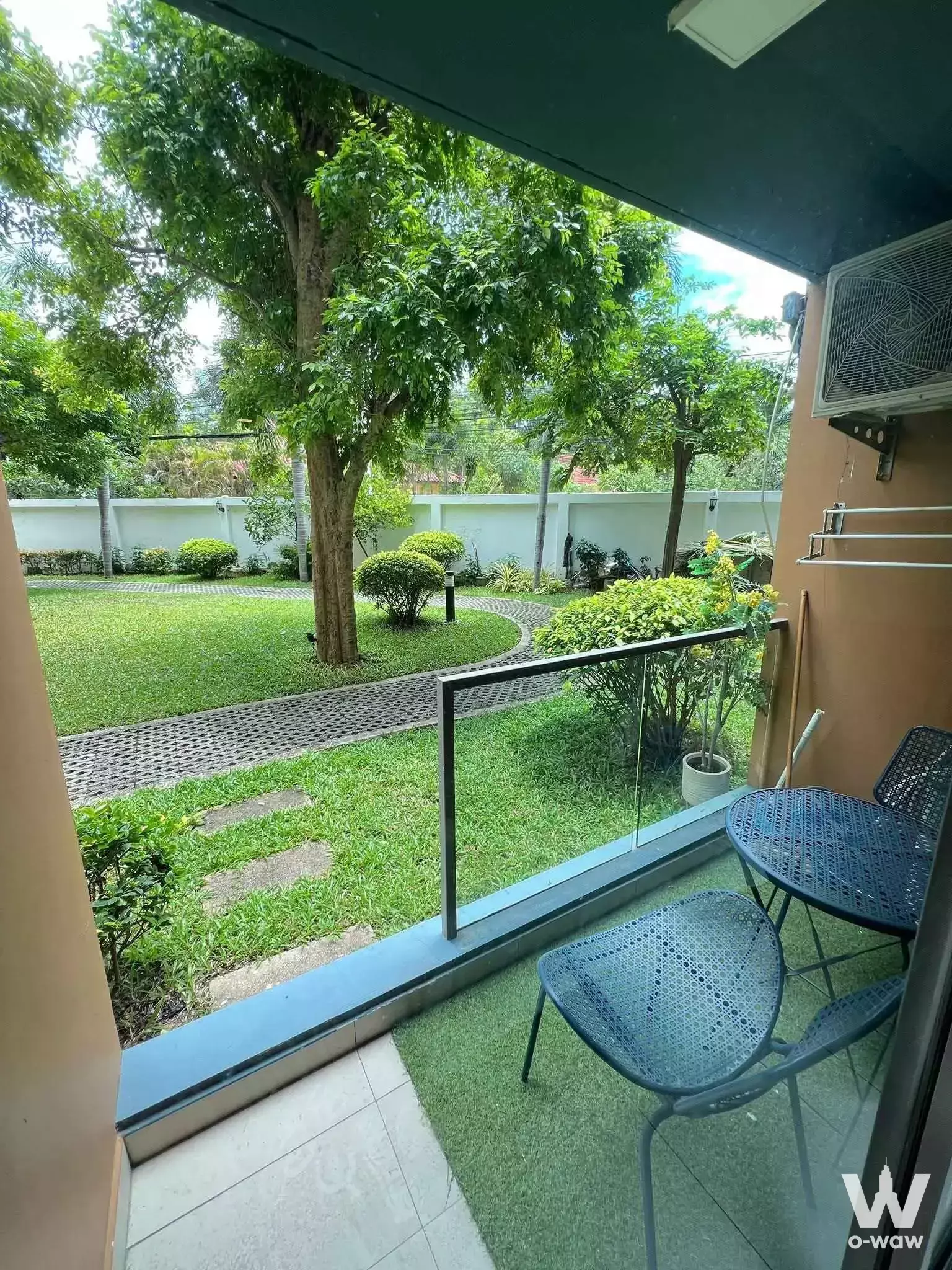 Balcony with dining set overlooking lush garden at Laguna Beach Resort 2 condo for rent
